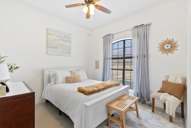 bedroom featuring ceiling fan and ornamental molding