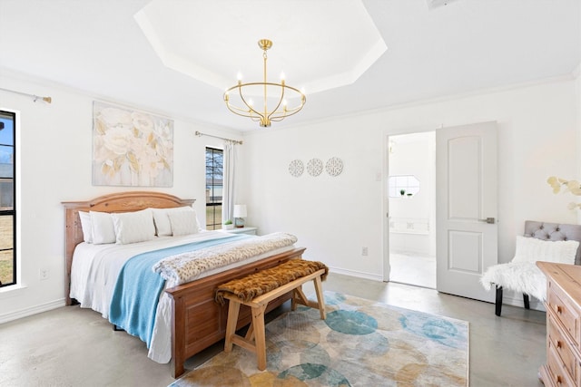 bedroom with a raised ceiling, crown molding, ensuite bathroom, and an inviting chandelier