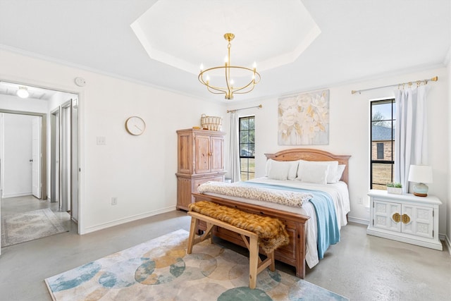 bedroom with multiple windows, concrete flooring, and a tray ceiling