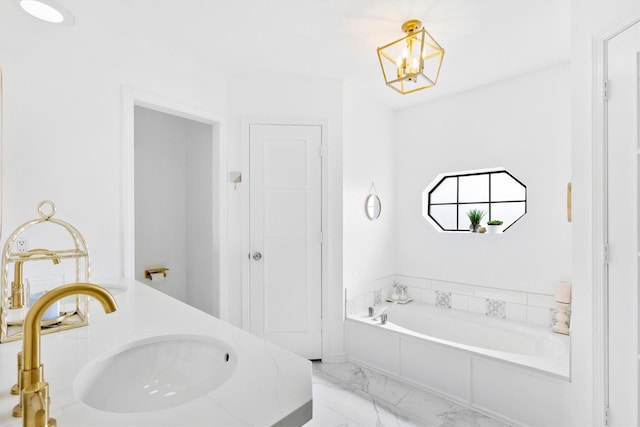 bathroom featuring a washtub, sink, and an inviting chandelier