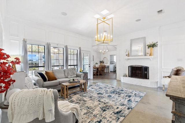 living room featuring a fireplace and an inviting chandelier