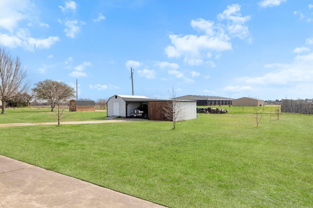 view of yard with a garage and an outdoor structure