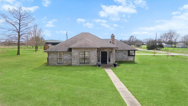 french country inspired facade featuring a front yard