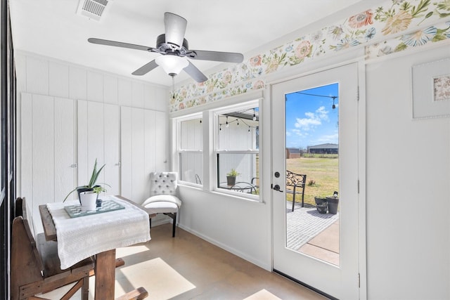 interior space with ceiling fan