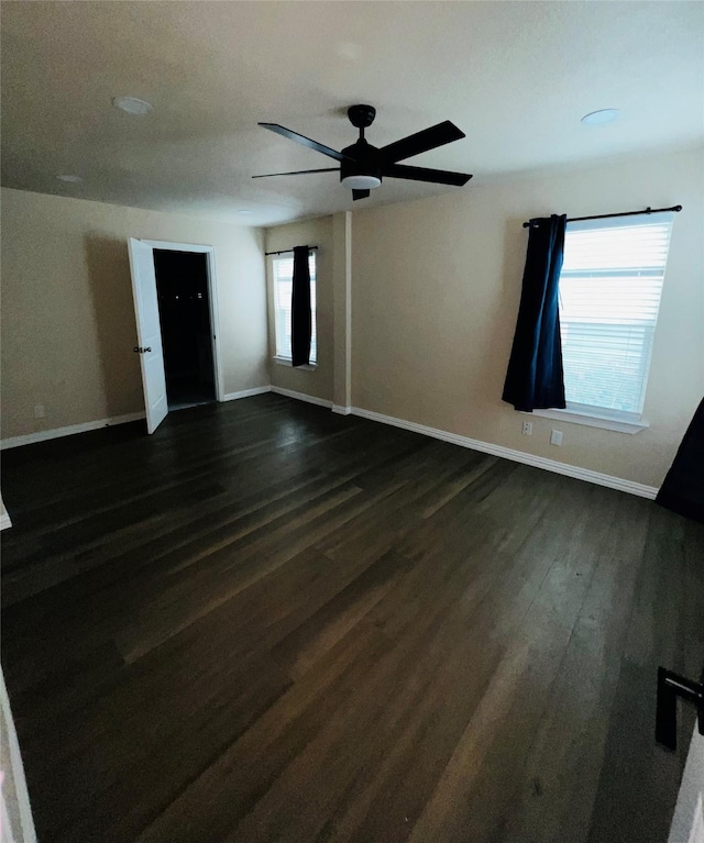 spare room with ceiling fan and dark hardwood / wood-style flooring