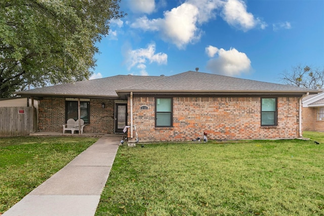 ranch-style house featuring a front yard and brick siding