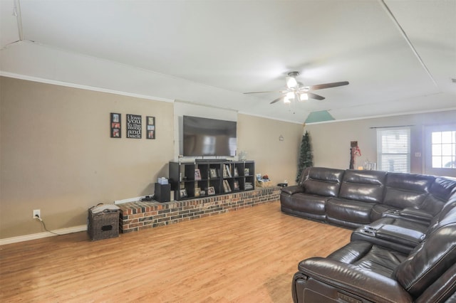 living area with ceiling fan, ornamental molding, wood finished floors, and baseboards