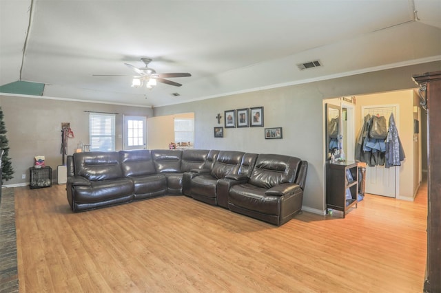 living room featuring ceiling fan, visible vents, wood finished floors, and ornamental molding