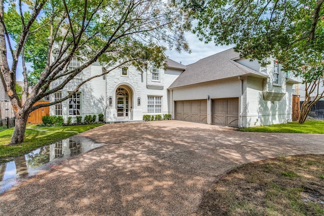 view of front of house featuring a garage and a front yard