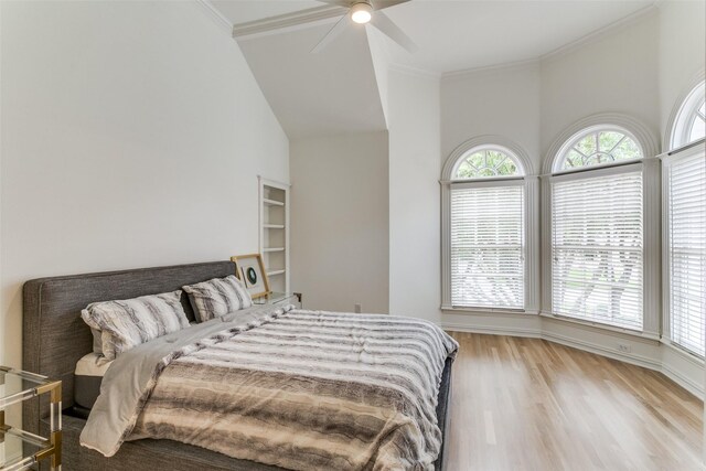 bedroom featuring ornamental molding, light hardwood / wood-style floors, and multiple windows