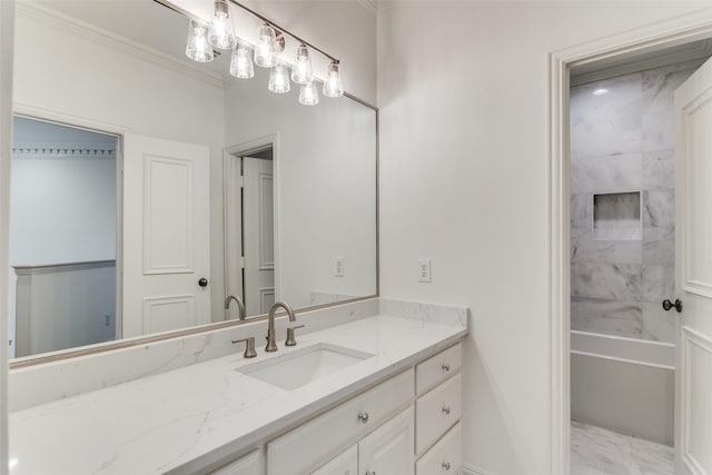 bathroom with vanity, crown molding, and tiled shower / bath