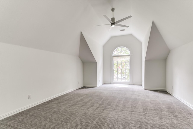 bonus room with vaulted ceiling, light colored carpet, and ceiling fan