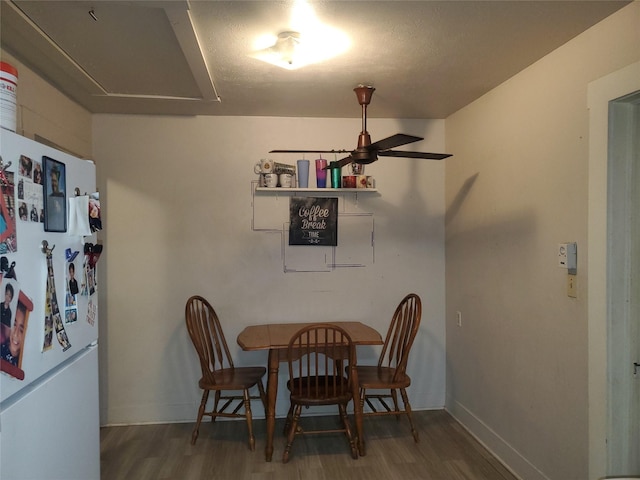 dining area featuring dark wood-style floors and baseboards