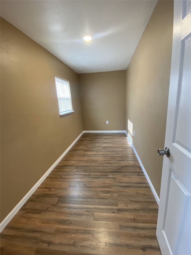 spare room with dark wood-type flooring