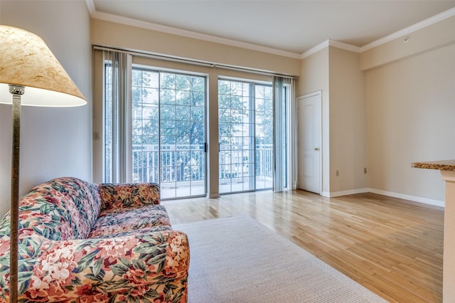 living room featuring ornamental molding and light wood-type flooring