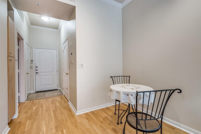 hall with crown molding and light wood-type flooring