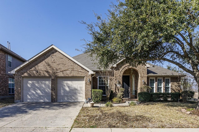 view of front of home with driveway, brick siding, and an attached garage