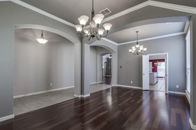 unfurnished dining area featuring wood-type flooring, ornamental molding, and a chandelier