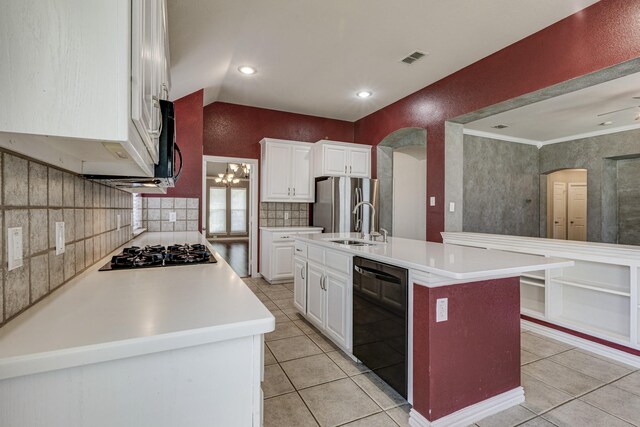 kitchen featuring lofted ceiling, plenty of natural light, light tile patterned floors, and white cabinets