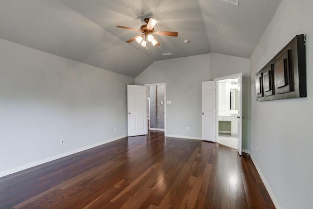 empty room featuring baseboards, dark wood-type flooring, lofted ceiling, and a ceiling fan