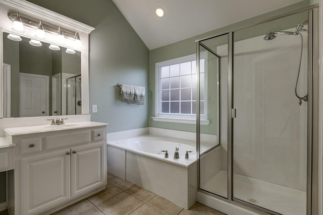 bathroom with vanity, tile patterned flooring, a shower stall, vaulted ceiling, and a garden tub