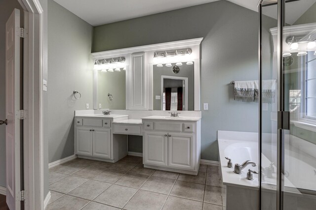 bathroom featuring tile patterned floors, vanity, separate shower and tub, and vaulted ceiling