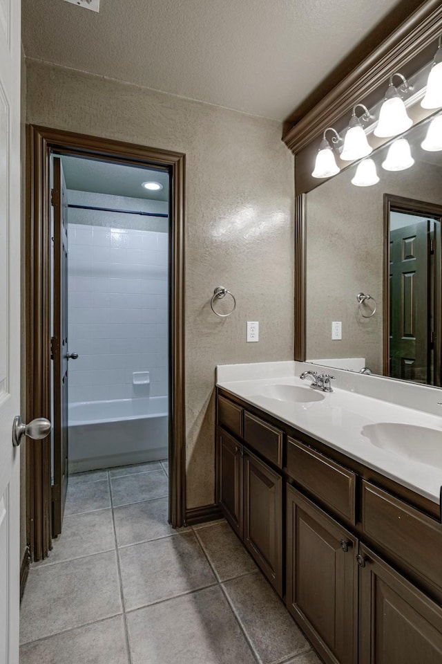 bathroom featuring vanity, tub / shower combination, tile patterned floors, and a textured ceiling