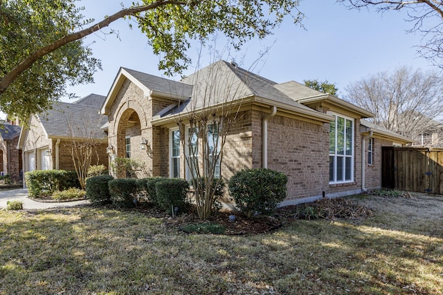 view of home's exterior with a garage and a lawn