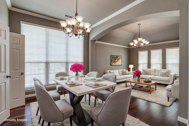 dining area with ornamental molding, dark wood-style floors, visible vents, and a chandelier