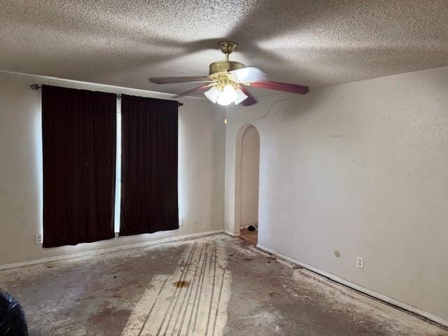 unfurnished room featuring ceiling fan and a textured ceiling