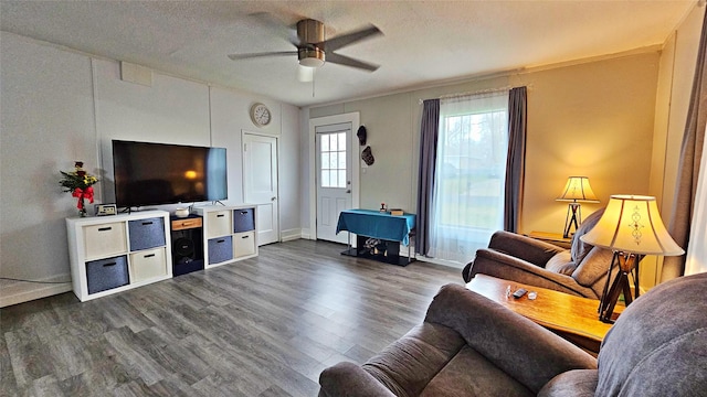 living room with dark hardwood / wood-style floors, a textured ceiling, and ceiling fan