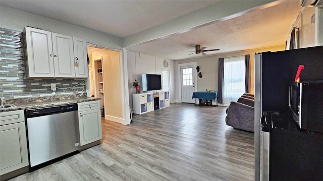 kitchen with white cabinetry, backsplash, ceiling fan, stainless steel appliances, and light wood-type flooring