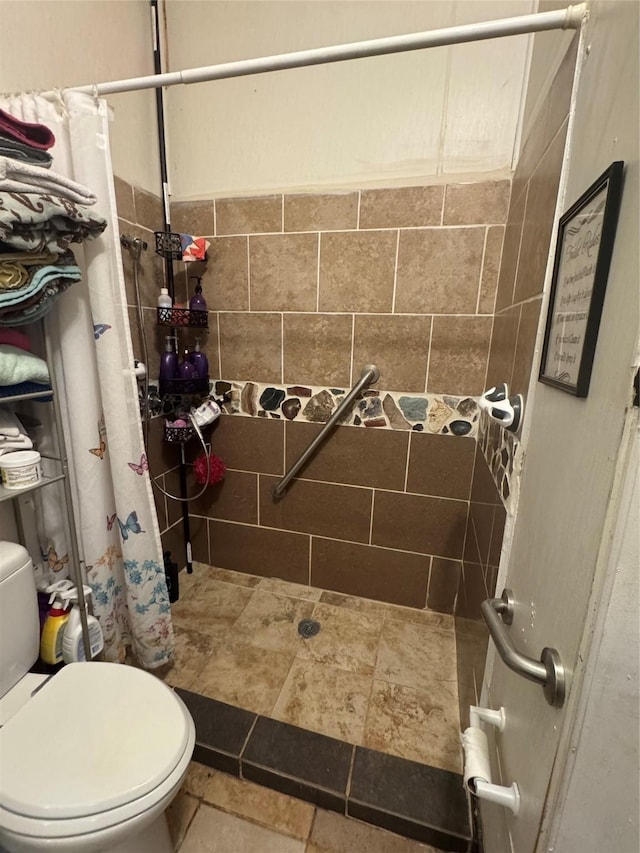 bathroom featuring toilet and a shower with shower curtain