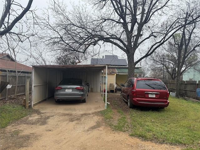 view of front facade with a carport and a front lawn