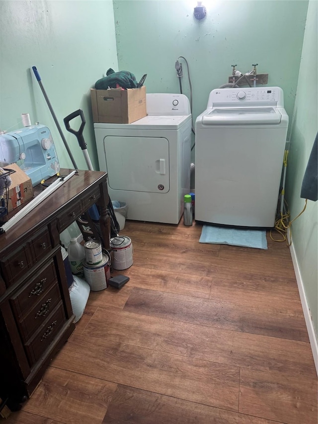 laundry room with hardwood / wood-style flooring and washer and clothes dryer