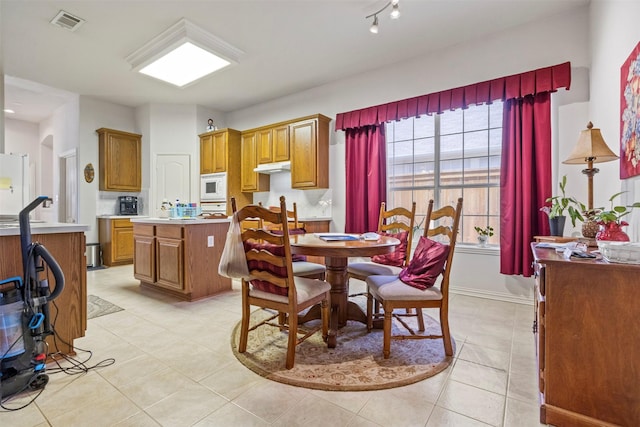 dining space featuring light tile patterned floors