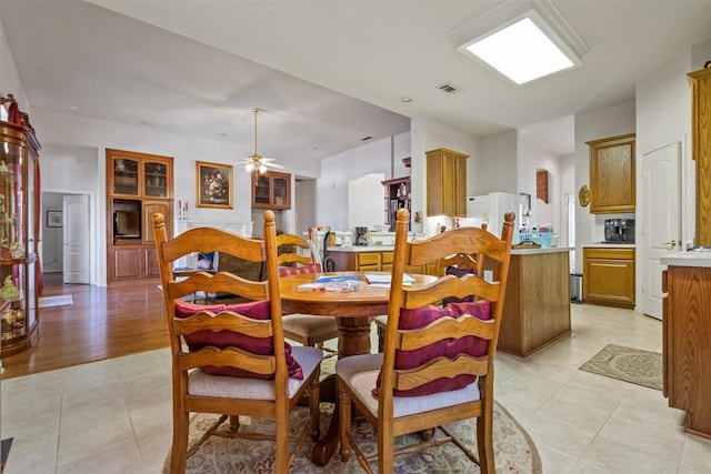 dining area featuring light tile patterned floors and ceiling fan