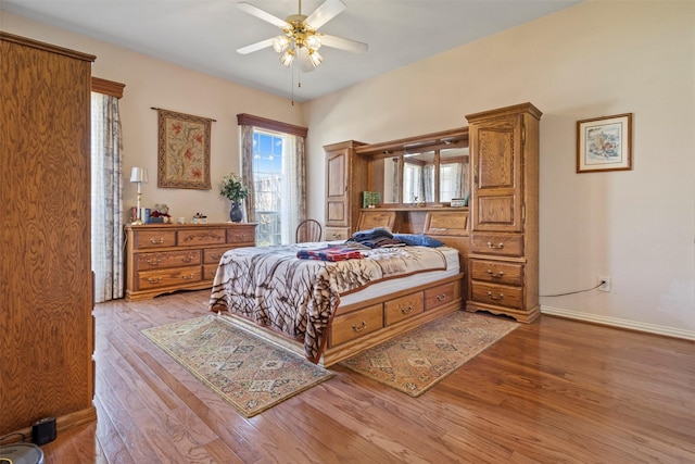 bedroom with ceiling fan and light wood-type flooring