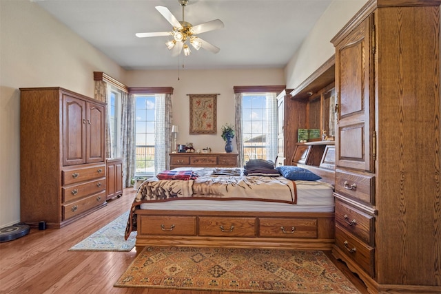 bedroom with ceiling fan and light hardwood / wood-style floors