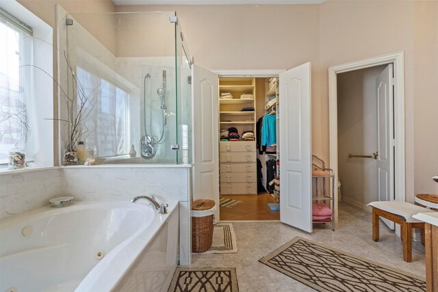 bathroom with tile patterned floors, plus walk in shower, and a wealth of natural light