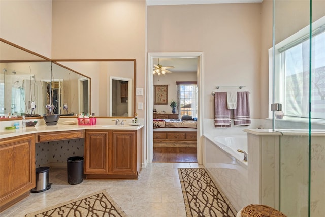 bathroom with vanity, tile patterned flooring, and a tub