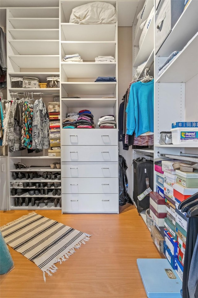 walk in closet with wood-type flooring