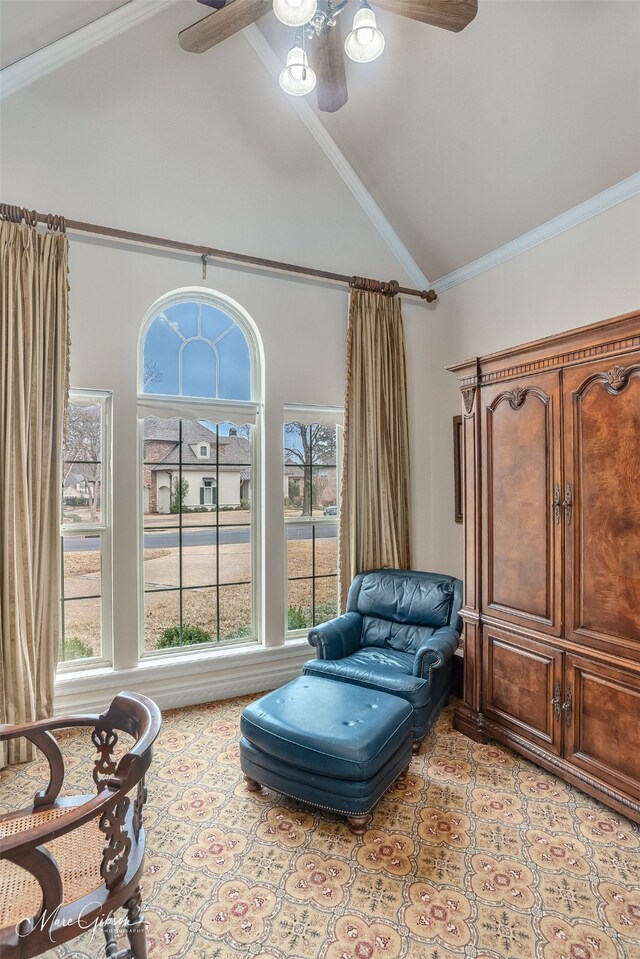 sitting room featuring crown molding, high vaulted ceiling, and ceiling fan