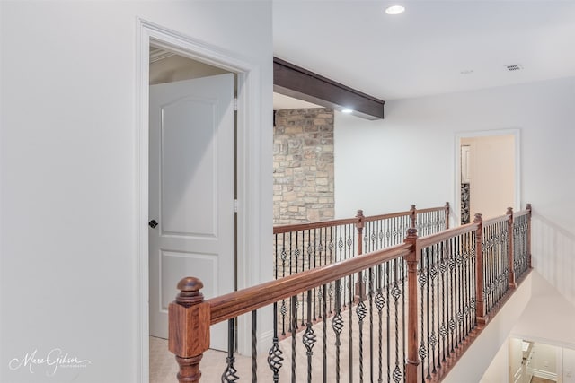 hallway featuring beamed ceiling