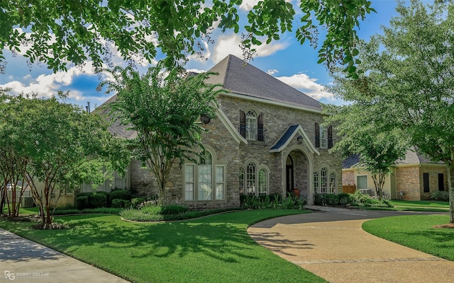 10910 Belle Cour Way, Shreveport, LA 71106 - french country home featuring stone siding and a front lawn