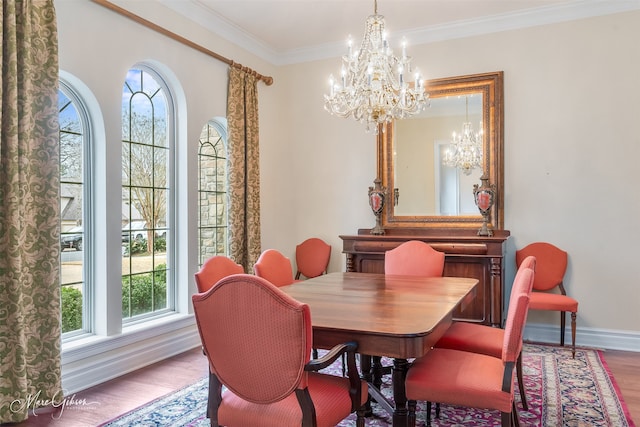 dining room featuring hardwood / wood-style flooring, ornamental molding, and a chandelier