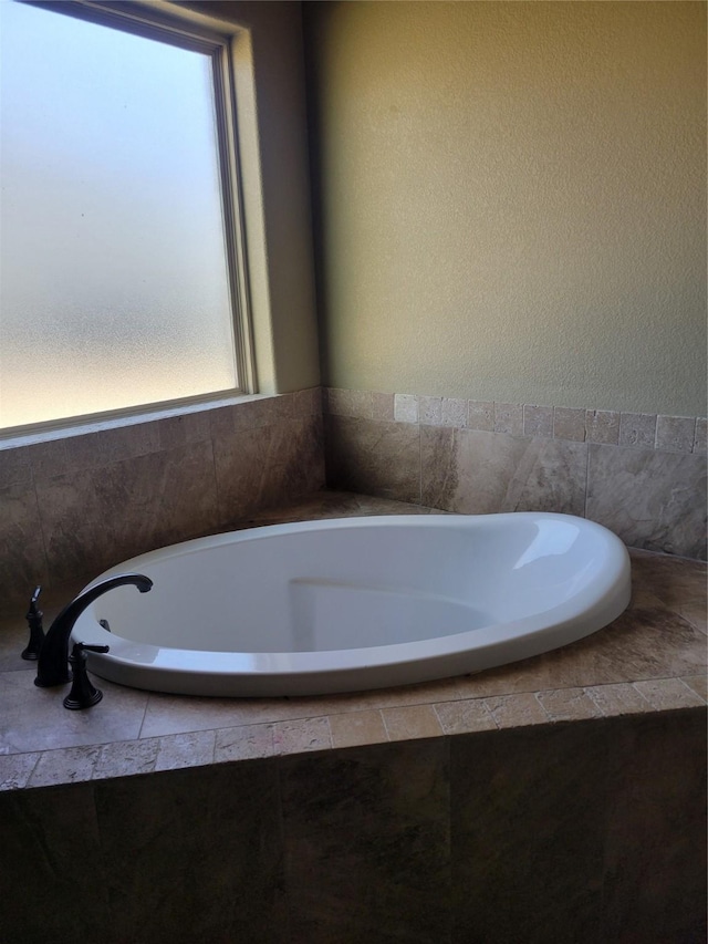 bathroom featuring tiled bath