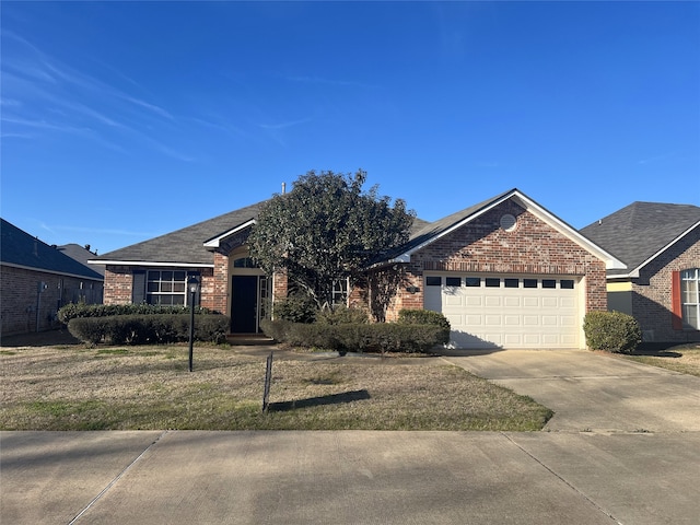 single story home with a garage, driveway, brick siding, and a front yard