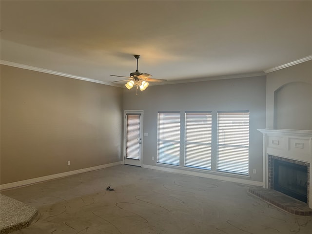 unfurnished living room featuring ceiling fan, a fireplace, baseboards, and crown molding