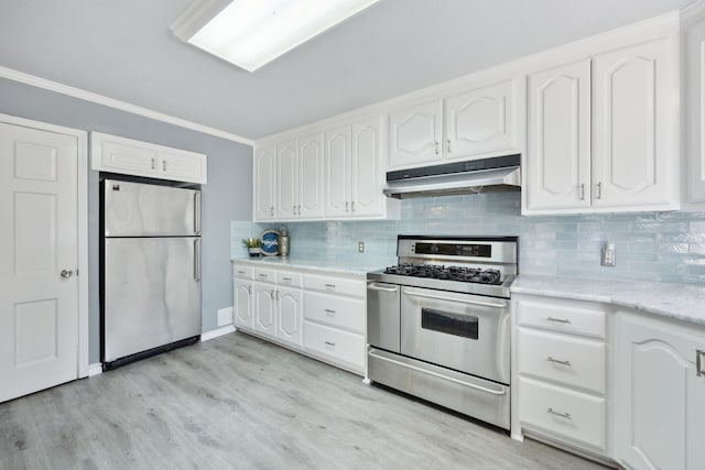 kitchen featuring stainless steel appliances, ornamental molding, white cabinets, and decorative backsplash